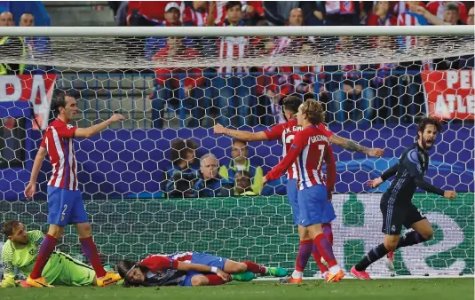  ?? — AP ?? Real Madrid’s Isco (right) celebrates after scoring against Atletico de Madrid in their Champions League semi-final second leg in Madrid on Wednesday. Real lost 1-2 but advanced to the final 4-2 aggregate.