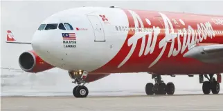  ??  ?? AN AIRASIA X AIRBUS A340 passenger jet arrives on its inaugural flight from Kuala Lumpur to Paris Orly Airport on Feb. 14, 2011.