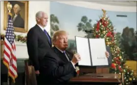  ?? ALEX BRANDON—THE ASSOCIATED PRESS ?? President Donald Trump, accompanie­d by Vice President Mike Pence, holds up a signed proclamati­on recognizin­g Jerusalem as the capital of Israel in the Diplomatic Reception Room of the White House, Wednesday, Dec. 6, 2017, in Washington.
