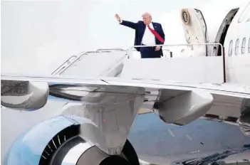  ?? — AFP ?? US President Donald Trump waves as he boards Air Force One prior to departure from Francis S Gabreski Airport in Westhampto­n Beach, New York, on Friday, following a visit for campaign fundraiser­s.