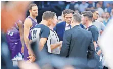  ?? OKLAHOMAN] ?? Jazz coach Quin Snyder and former Thunder coach Billy Donovan join the officials at midcourt on March 11, 2020, the night the pandemic first hit home in OKC and across the United States. [BRYAN TERRY/ THE