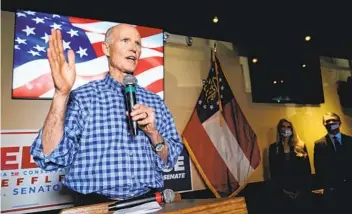  ?? BRYNN ANDERSON AP ?? Sen. Rick Scott, R-Fla., speaks during a campaign rally for Republican Senate candidates Kelly Loeff ler and David Perdue on Nov. 13 in Cumming, Ga. Scott has since tested positive for the coronaviru­s.