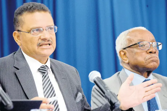  ?? FILE ?? Dr Derrick McKoy (left) and retired Justice Karl Harrison, integrity commission­ers, field questions from the media during a press briefing on May 13.