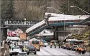  ?? STEPHEN BRASHEAR/GETTY ?? Emergency crews work on a Amtrak train derailment last week in Seattle. Some say PTC could’ve made a difference.