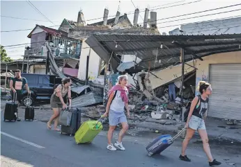  ?? Reuters; Orla Carbery ?? Above, Lombok and Bali are popular tourist destinatio­ns. Left, Orla Carbery with her children Conor, Niamh and Aoife on holiday in Bali before the earthquake struck