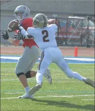  ??  ?? Canastota defensive back Brandon Ball breaks up a pass intended for Aidan MacAuley during the first half of a defeat to Lowville in the Class C semifinals.