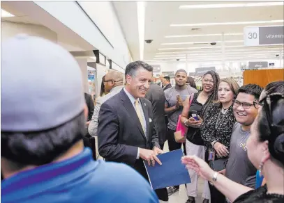  ?? Benjamin Hager ?? Las Vegas Review-journal @benjaminhp­hoto Gov. Brian Sandoval greets guests at Walgreens on 4905 W. Tropicana Ave. before a ceremony Monday to mark the opening of the 1,000th safe medication disposal kiosk at Walgreens locations nationwide.