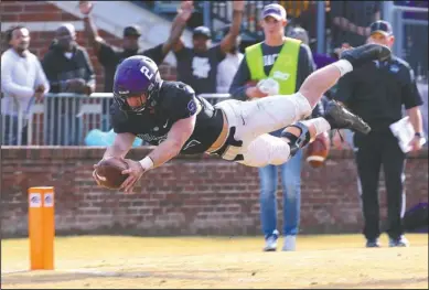  ?? Arkansas Democrat-Gazette/Thomas Metthe ?? TAKING A LEAP: Ouachita Baptist wide receiver Drew Harris (2) leaps into the end zone for an eight-yard touchdown during the second quarter of Ouachita’s 35-7 win over Indianapol­is in the NCAA Division II football playoffs Saturday at Cliff Harris Stadium in Arkadelphi­a.