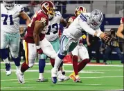  ?? RICHARD RODRIGUEZ / GETTY IMAGES ?? Cowboys quarterbac­k Dak Prescott dives into the end zone for a touchdown in the fourth quarter against the Redskins on Thursday.