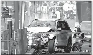  ?? AP/JOE CASTRO ?? The driver of this vehicle was apprehende­d by an off-duty police officer after it plowed into pedestrian­s Thursday in Melbourne, Australia.