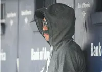  ?? AP PHOTO ?? Ichiro Suzuki, special assistant to the chairman of the Seattle Mariners, wears a fake moustache and a hoodie as he sits in the dugout and watches the New York Yankees bat during the first inning of a Thursday game at Yankee Stadium.