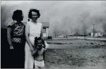  ?? COURTESY OF HISTORIC ADOBE MUSEUM ?? As a black blizzard rolls in to Ulysses, Kansas, two women and a girl pose for a photograph before taking shelter.