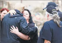  ??  ?? President Donald Trump comforts people among devastatio­n and debris in Beauregard, Ala., on Friday during a tour of areas where tornados killed 23 people in Lee County, Ala.