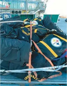  ?? AP ?? Steelers luggage sits on the tarmac at a Kansas City airport.