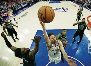  ?? MATT SLOCUM/THE ASSOCIATED PRESS ?? Philadelph­ia 76ers’ T.J. McConnell, center, goes up for a shot against Boston Celtics’ Jaylen Brown, left, and Terry Rozier during the second half of Game 4 of an NBA basketball second-round playoff series, Monday, May 7, 2018, in Philadelph­ia.