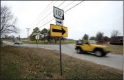  ?? NWA Democrat-Gazette/CHARLIE KAIJO ?? Cars pass by Thursday the corner of West Van Asche Drive and Howard Nickell Road in Fayettevil­le. The city is considerin­g partnering with Washington County to to improve the intersecti­on.