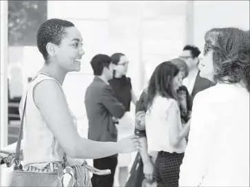  ?? Photograph­s by Christina House For The Times ?? HANNA GIRMA, left, an assistant curator for the Mistake Room, chats with Joan Weinstein at the Getty.