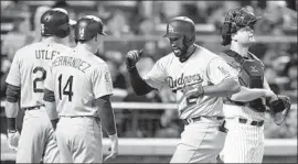  ?? Jim McIsaac Getty Images ?? MATT KEMP runs past Mets catcher Devin Mesoraco and is greeted by Chase Utley, left, and Enrique Hernandez after hitting an eighth-inning pinch-hit slam.