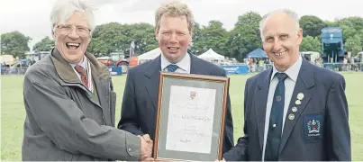  ??  ?? James Ivory, Deputy Lord Lieutenant of Angus, and ploughing veteran Dave Carnegie, right, handed over the award.