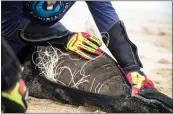  ?? ALAN VAN GYSEN, NOW NOW MEDIA VIA THE NEW YORK TIMES ?? Naude Dreyer removes netting wrapped around a seal. Ocean Conservati­on Namibia is disentangl­ing a record number of seals, while broadcasti­ng the perils of marine debris in a largely feel good way.