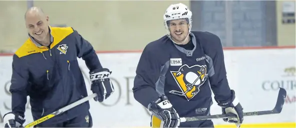  ?? KEITH SRAKOCIC/AP ?? Pittsburgh’s Sidney Crosby skates past assistant coach Rick Tocchet during team practice on Friday. It’s still uncertain whether he will be available for Game 5 on Saturday night in Washington.