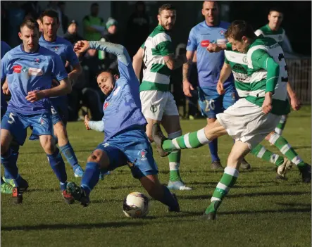  ??  ?? Robin Dempsey of North End United spreads himself to block a strike from Mikey Dempsey of Shamrock Rovers during Sunday’s Premier Division match at Peter Quinn Park.