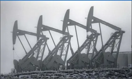  ?? ERIC GAY / ASSOCIATED PRESS ?? Oil pump jacks work in unison in Williston, N.D. The price of oil has fallen about 60 percent from a peak last June, then rebounded over 20 percent as February began. Various factors point to the continued rise of oil prices; but there are factors,...