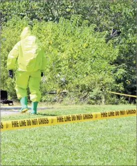  ??  ?? A member of the Rockmart Fire Department’s HAZMAT team goes toward an Aragon house where a meth lab was believed to have been found on Aug. 30. Gear like this keeps firefighte­rs safe from the dangers of chemical spills, drug labs and more, but they...