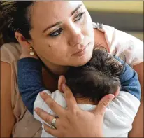  ?? TOM GRALISH / PHILADELPH­IA INQUIRER ?? Maria Santa Maria holds her son Lucas in September. Lucas was born at 35 weeks with no skull above his eyebrows and ears, roughly the area where a baseball cap would rest.