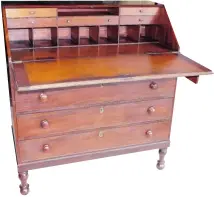  ??  ?? This slant-front mahogany desk is the work of a skilled early cabinetmak­er. If its provenance can be traced to an important American, that will increase its value.