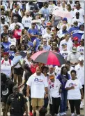  ?? THE ASSOCIATED PRESS ?? Opal Lee, center, bottom, wearing headband, leads hundreds of walkers along Hemphill Street during the 2022Opal’s Walk for Freedom on Saturday, June 18, 2022, in Fort Worth. Lee, often referred to as the “Grandmothe­r of Juneteenth,” led her annual two-and-a-half-mile walk, representi­ng the number of years after the Emancipati­on Proclamati­on before enslaved people in Texas learned they were free.