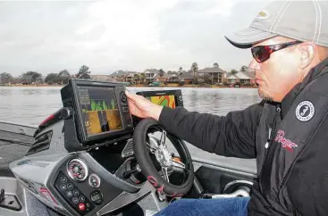  ?? Shannon Tompkins / Houston Chronicle ?? Profession­al bass tournament angler Keith Combs uses some of his boat’s extensive marine electronic­s to help locate potential fishing areas while scouting Lake Conroe, site of the 2017 Bassmaster Classic in March.