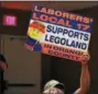  ?? MID-HUDSON NEWS NETWORK ?? A Legoland supporter holds up a sign during Thursday’s meeting of the Goshen Planning Board.