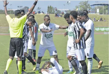  ??  ?? Referee Earon Reddy makes a call after Shahil Dave of Suva was fouled by Dreketi player at Churchill Park in Lautoka on July 21, 2018.Photo: Waisea Nasokia