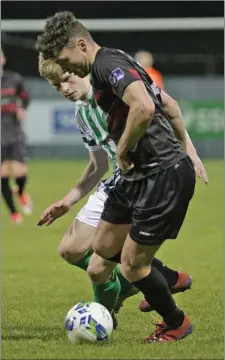  ??  ?? Defender Paul Cleary shielding the ball from Bray’s Darragh Lynch.