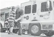  ?? Alvin Community College ?? Alvin Community College Lab School student Kyle Jones, 4, learns how to shoot a fire hose with Alvin volunteer firefighte­r Robert Clark.