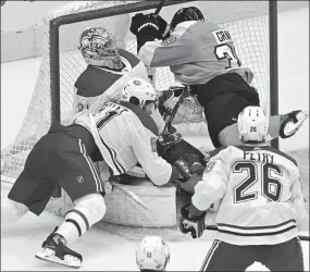  ?? The Associated Press ?? Philadelph­ia Flyers’ Derek Grant and Montreal Canadiens’ Xavier Ouellet crash into Canadiens goaltender Carey Price during first-period NHL Eastern Conference Stanley Cup playoff action in Toronto on Wednesday.