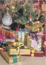  ?? ?? TAKE A BOW: Beautifull­y wrapped presents under Siobhan’s tree and a close-up of the maximalist tree in her reception room, top.