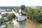  ?? JIM LO SCALZO/EPA-EFE ?? Floodwater­s engulf Fayettevil­le, N.C., on Monday. The Cape Fear River Valley was expected to see record flood levels.