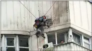  ?? THE ASSOCIATED PRESS ?? In this image taken from video, investigat­ors inspect the building after a Ukrainian drone damaged an apartment building in Moscow, Russia, on Tuesday.