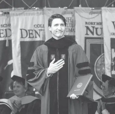  ?? PHOTOS: DREW ANGERER / GETTY IMAGES ?? Clad in a graduation gown, Prime Minister Justin Trudeau acknowledg­es the crowd after receiving an honorary doctor of laws degree at New York University’s commenceme­nt ceremony at Yankee Stadium on Wednesday.