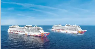  ??  ?? The two sister ships, World Dream (right) and Genting Dream. — Dream Cruises