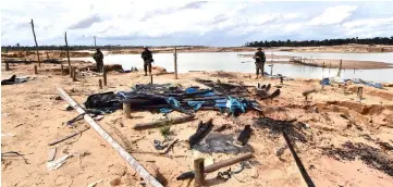  ??  ?? Peruvian military and police take over an illegal miner’s village during the ‘Mercury’ joint operation in the Amazon jungle over the river basin of the Madre de Dios region, in southeast Peru. — AFP photo