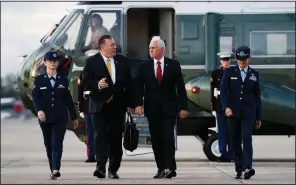  ?? AP/JACQUELYN MARTIN ?? Secretary of State Mike Pompeo and Vice President Mike Pence arrive at Andrews Air Force Base, Md., on Wednesday on their way to Turkey to try to persuade Turkish President Recep Tayyip Erdogan to stop the offensive in Syria, possibly using the threat of sanctions.