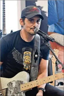  ?? GETTY IMAGES FOR NAMM PHOTO BY JASON DAVIS/ ?? Recording artist Brad Paisley debuts his new signature guitar, a Road Worn Fender Telecaster, at the Summer NAMM show opening at Music City Center on July 13 in Nashville, Tenn. Paisley will perform at Riverbend Music Center in Cincinnati on Aug. 10.