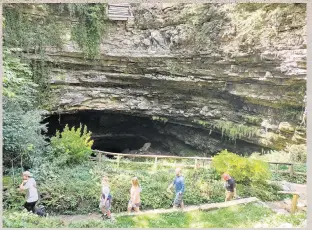  ?? PHOTOS BY KATHY WITT TNS ?? At top, a pioneer adventure awaits at the Conestoga wagon accommodat­ions at Horse Cave KOA Holiday. Above, the main entrance to Hidden River Cave is off Main Street in downtown Horse Cave, Kentucky.