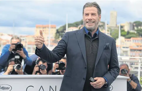  ??  ?? I’M BACK: US actor John Travolta poses during a photocall for the film ‘Gotti’ at the 71st edition of the Cannes Film Festival in Cannes, southern France.