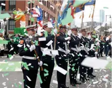  ?? ?? UNFAZED: The Boston Fire Department honor guard stands in a sea of confetti.