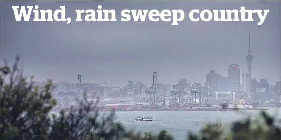  ?? Picture / Nick Reed ?? The Auckland CBD is covered with rain, as seen from North Head, as the big wet starts to hit Auckland and the rest of the country.