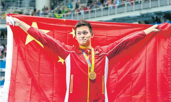  ??  ?? Sun Yang celebrates with his 200m freestyle gold medal at the 2016 Olympics.